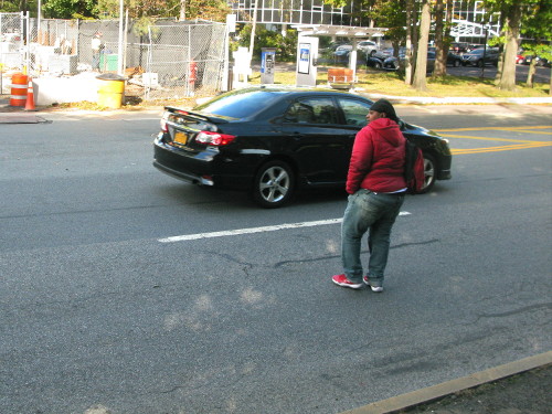 Person walking across a 5 lane road. People driving are not stopping for them.