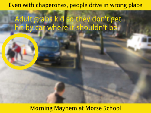 Screen capture of video. Morning Mayhem at Morse School. Shows an adult grabbing a child so they don't get hit by a car.