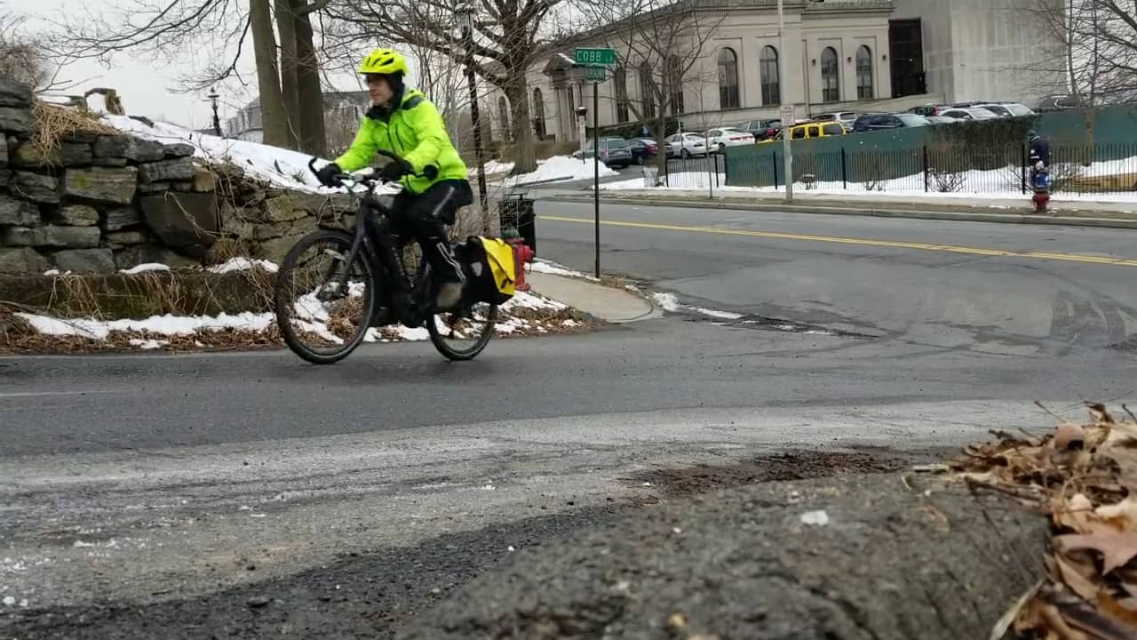 Person riding an ebike up a steep hill.