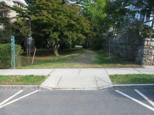 Curb ramp for the Old Croton Aqueduct leading to clear trail.