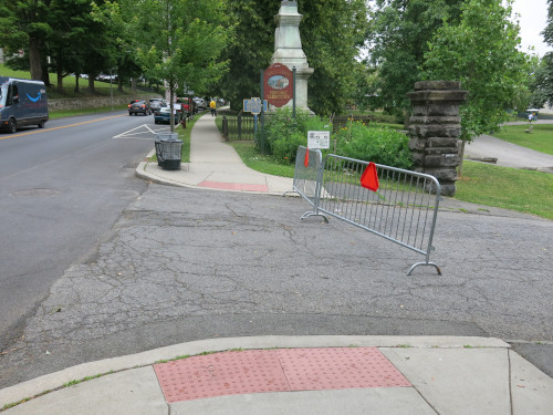 Photo of 'french' barriers across a park driveway.