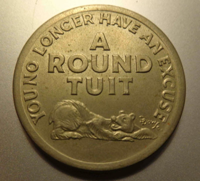 A large coin that says 'A Round Tuit' in the middle and 'You no longer have an excuse' next to the perimeter.