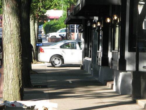 Car parked on the sidewalk along Beekman Ave